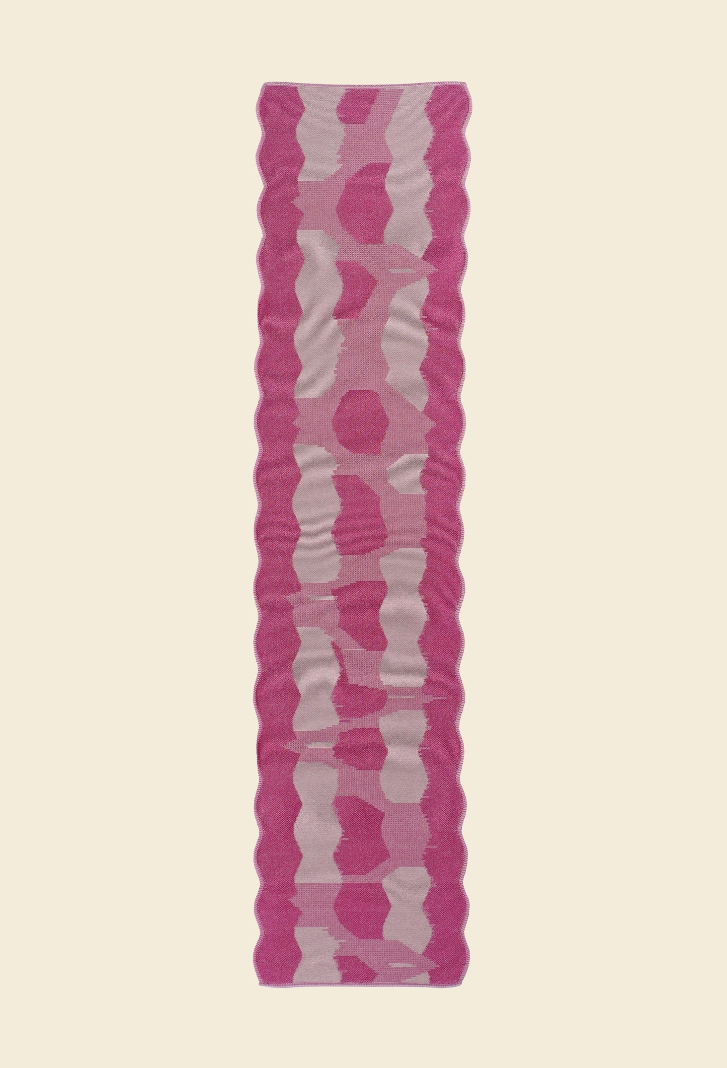 back top view of pink knit organic cotton and viscose table runner with abstract pattern and wavy edges