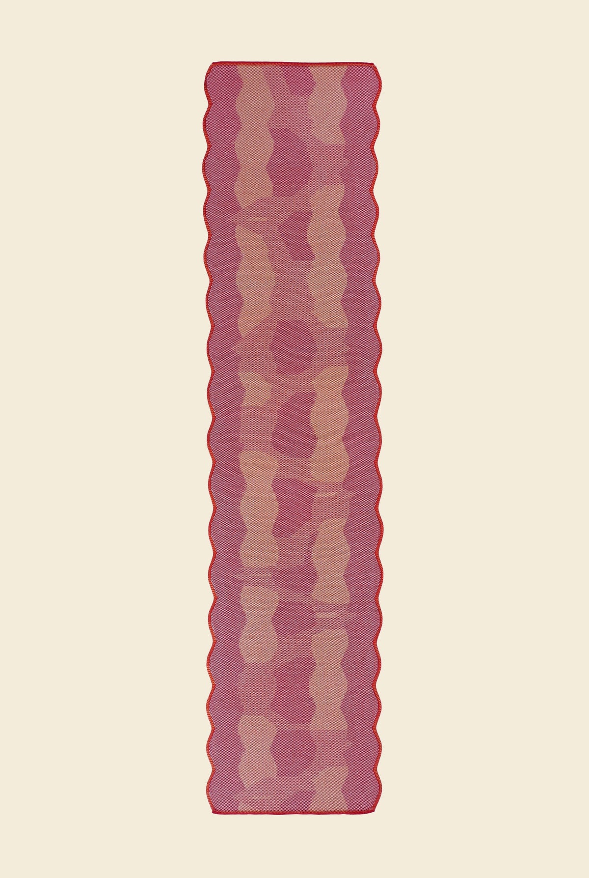 top view of red knit organic cotton and viscose table runner with abstract pattern and wavy edges