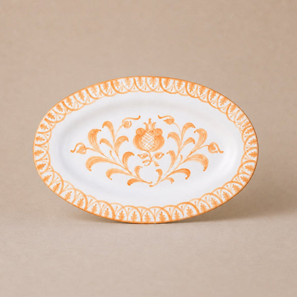 Decorative plate with orange floral pattern on a beige background