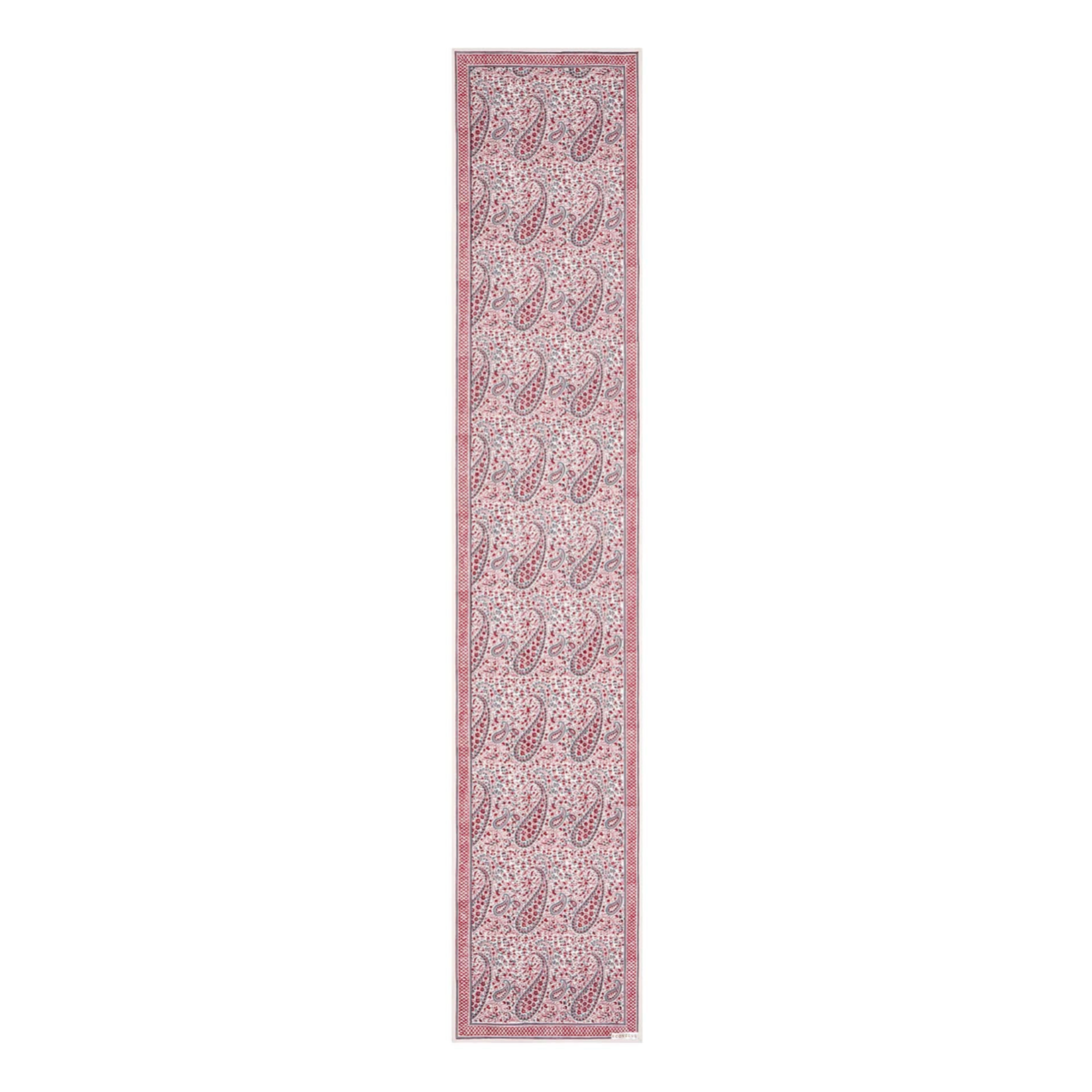 Long narrow block printed paisley design pink and white patterned table runner on a white background