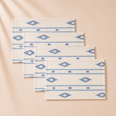 Set of four rectangular mats with blue geometric patterns on a beige background