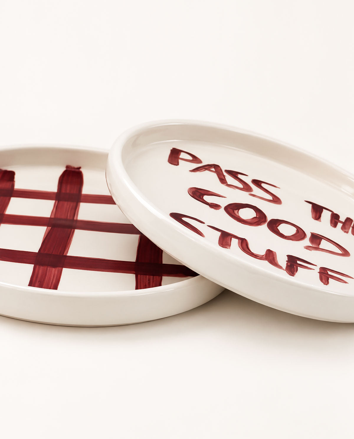 Contemporary handmade ceramic dessert plate featuring expressive burgundy lettering