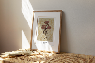 fine art print of a poppy flower with a human face in one of the blooms on a textured background