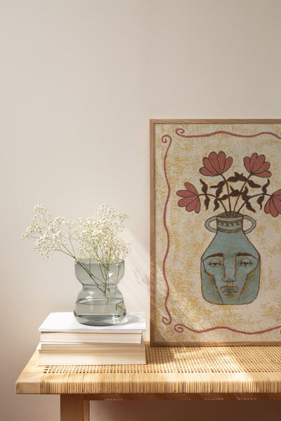 art print of a human head shaped like a vase with flowers in muted colors