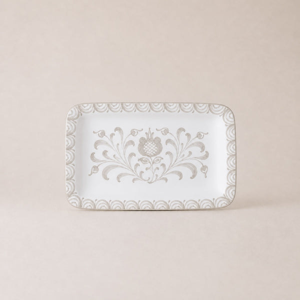 Decorative white plate with floral patterns on a beige background