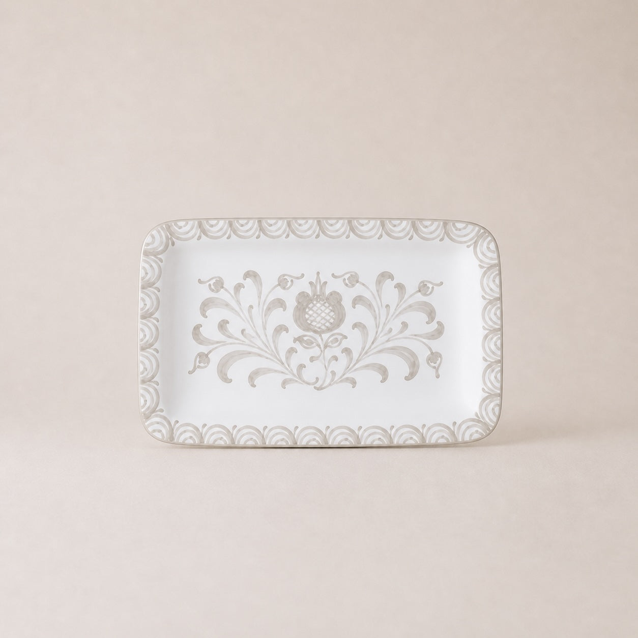 Decorative white plate with floral patterns on a beige background