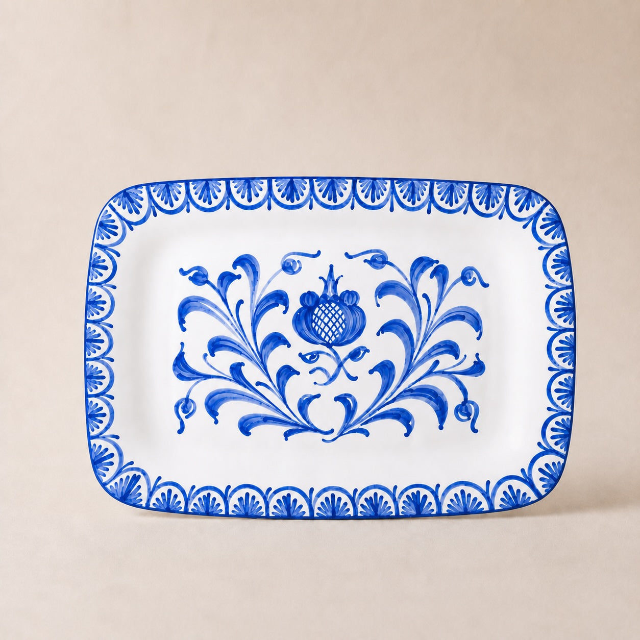 Rectangular plate with blue floral design on a beige background