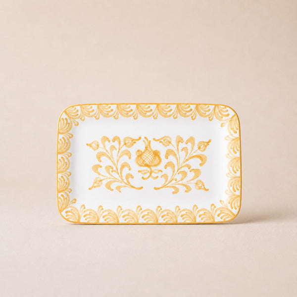 Decorative tray with gold floral patterns on a beige background