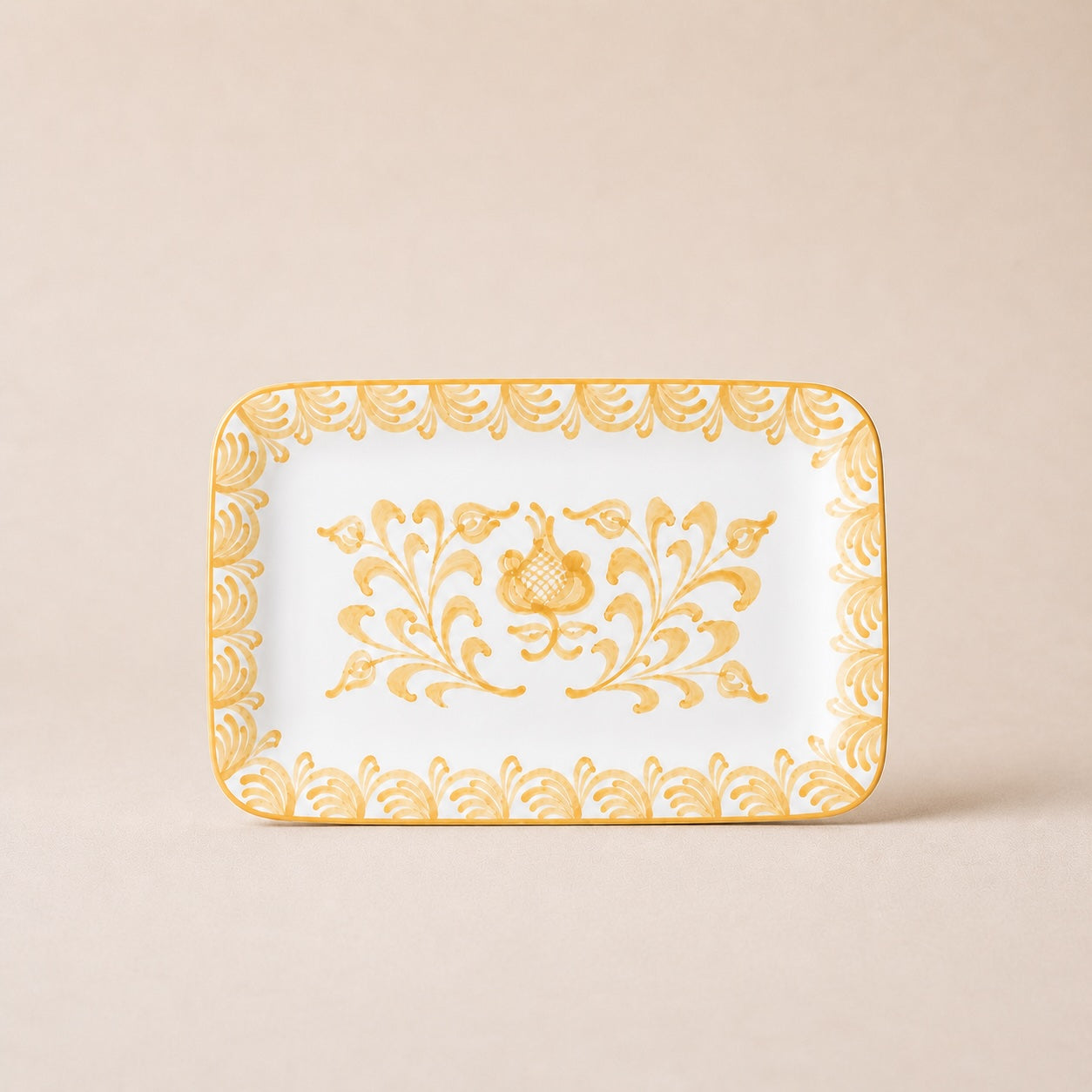 Decorative tray with gold floral patterns on a beige background
