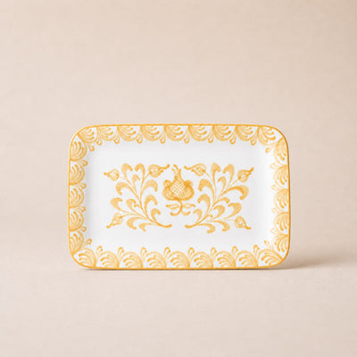 Decorative tray with gold floral patterns on a beige background