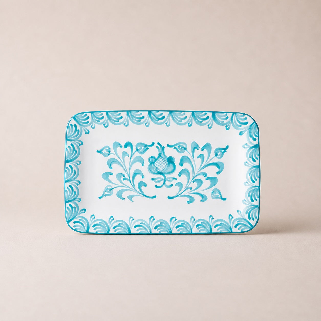 Decorative tray with blue floral pattern on a beige background