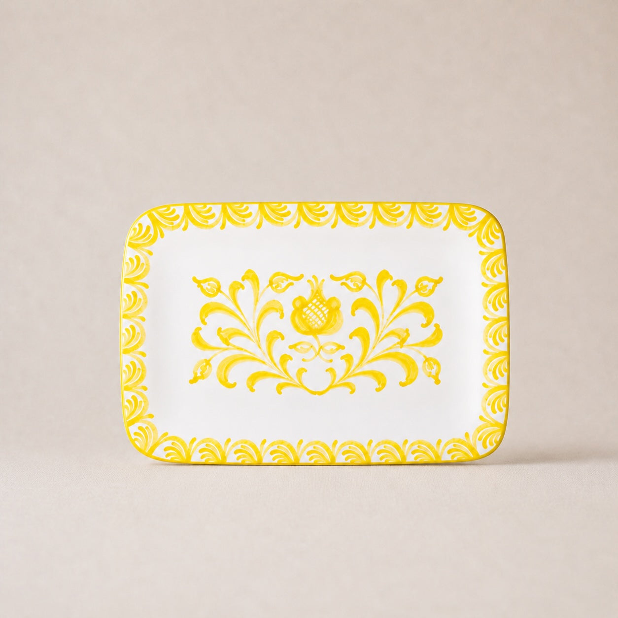 Decorative tray with yellow floral pattern on a beige background