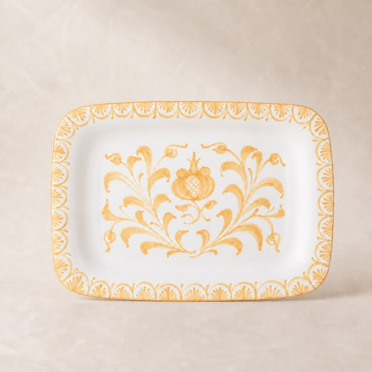 Decorative plate with gold floral pattern on a beige background