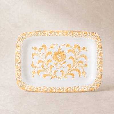 Decorative plate with gold floral pattern on a beige background