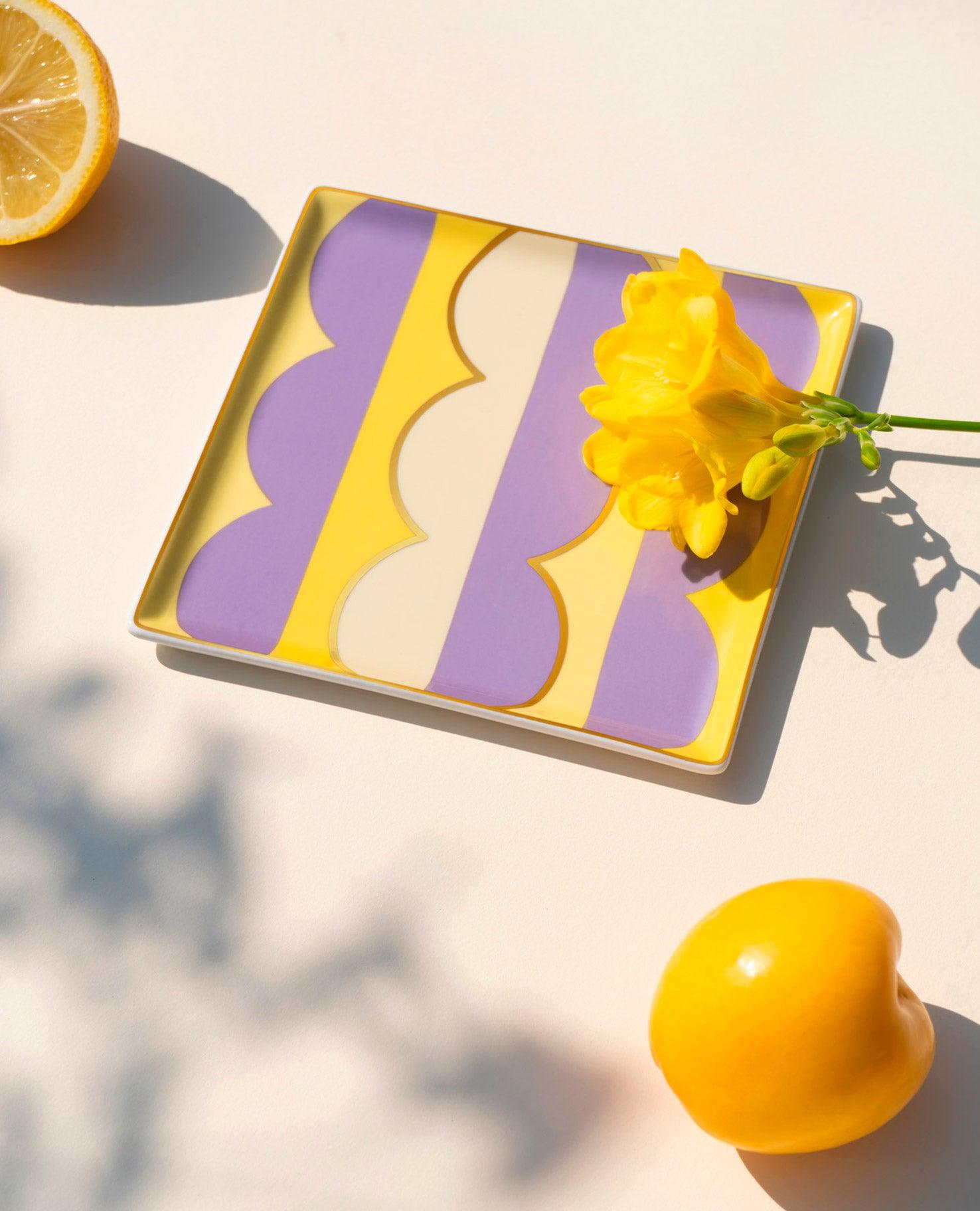 The OCTAEVO Riviera Wave Ceramic Tray adds vibrant yellow and purple flair to your tablescape.