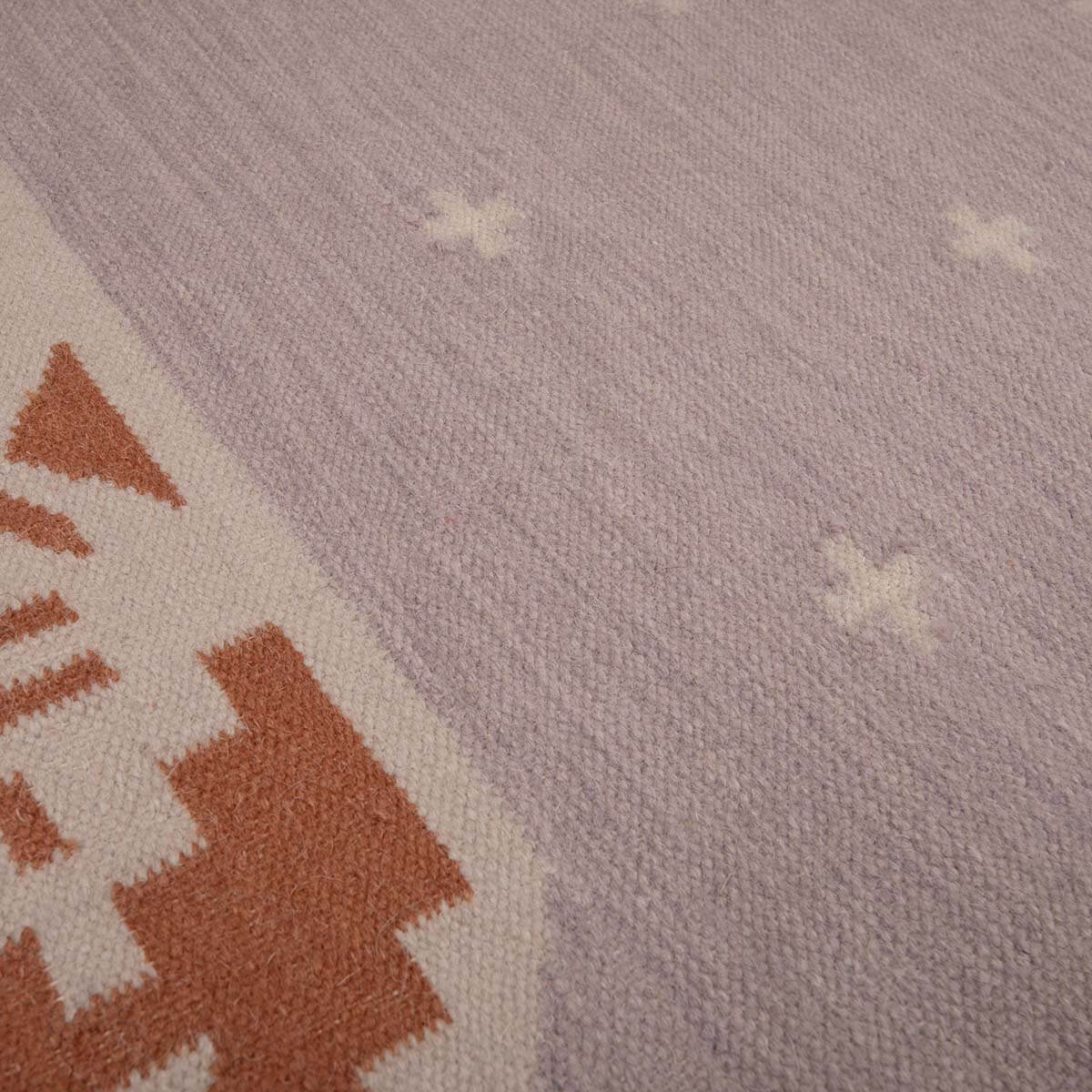 Detail of Manali flatweave stone and terracotta rug in natural earthy tones