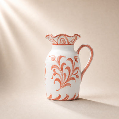 Ceramic pitcher with floral pattern on a beige background