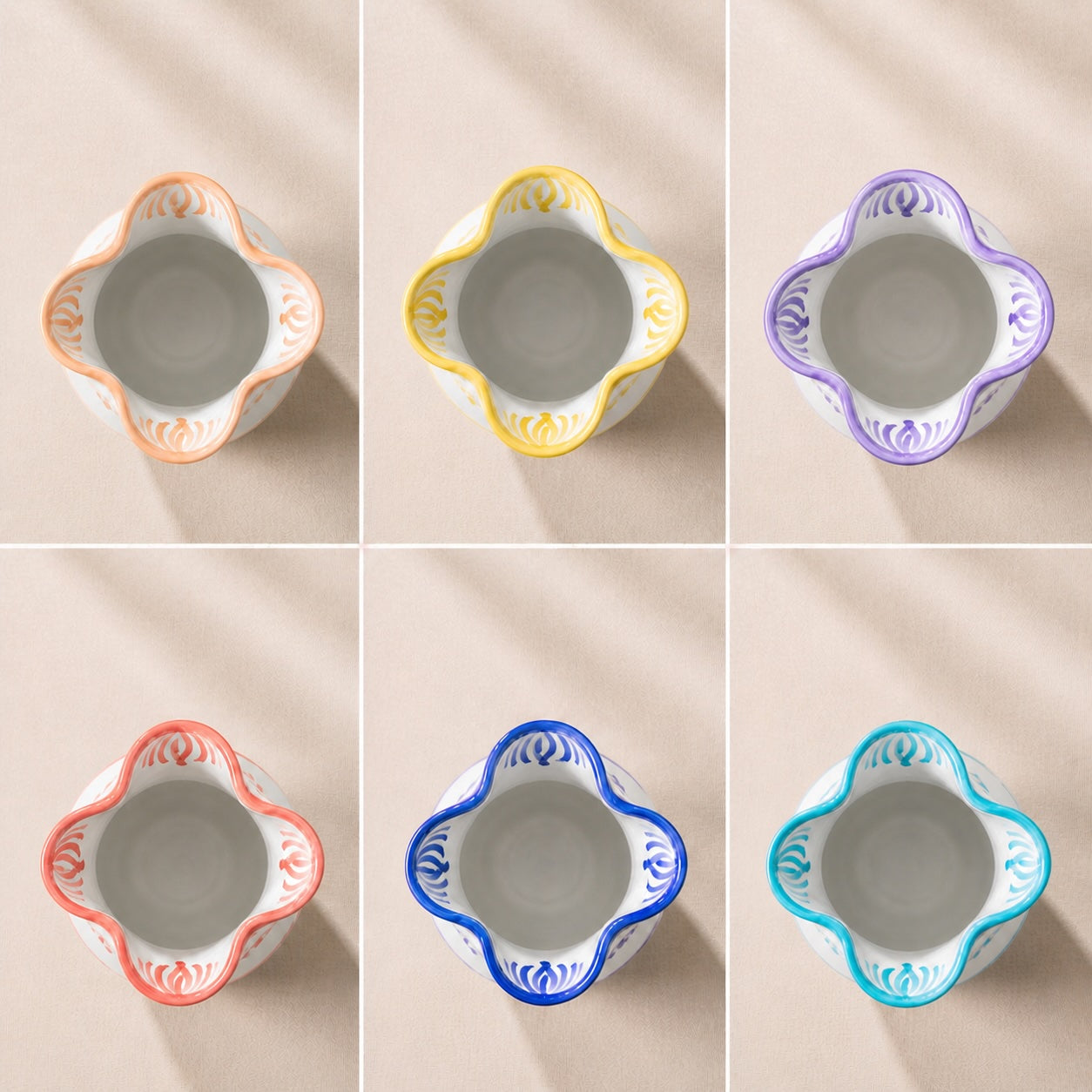 Set of six ceramic bowls with colorful decorative rims on a beige background - lifestyle