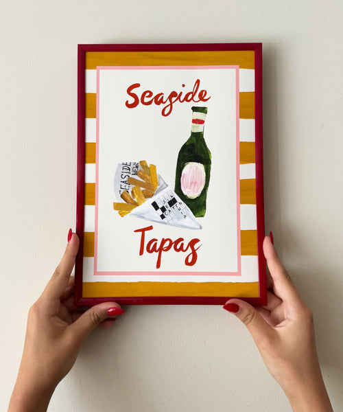 Seaside Tapas print, chips in newspaper and beer bottle with striped border being held
