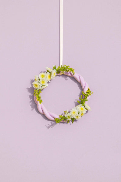 The purple OCTAEVO Sicilia Ceramic Trivet is displayed on a wall, adding a decorative pastel touch.