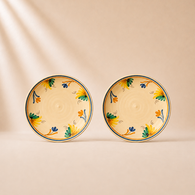 Two ceramic plates with floral patterns on a beige background