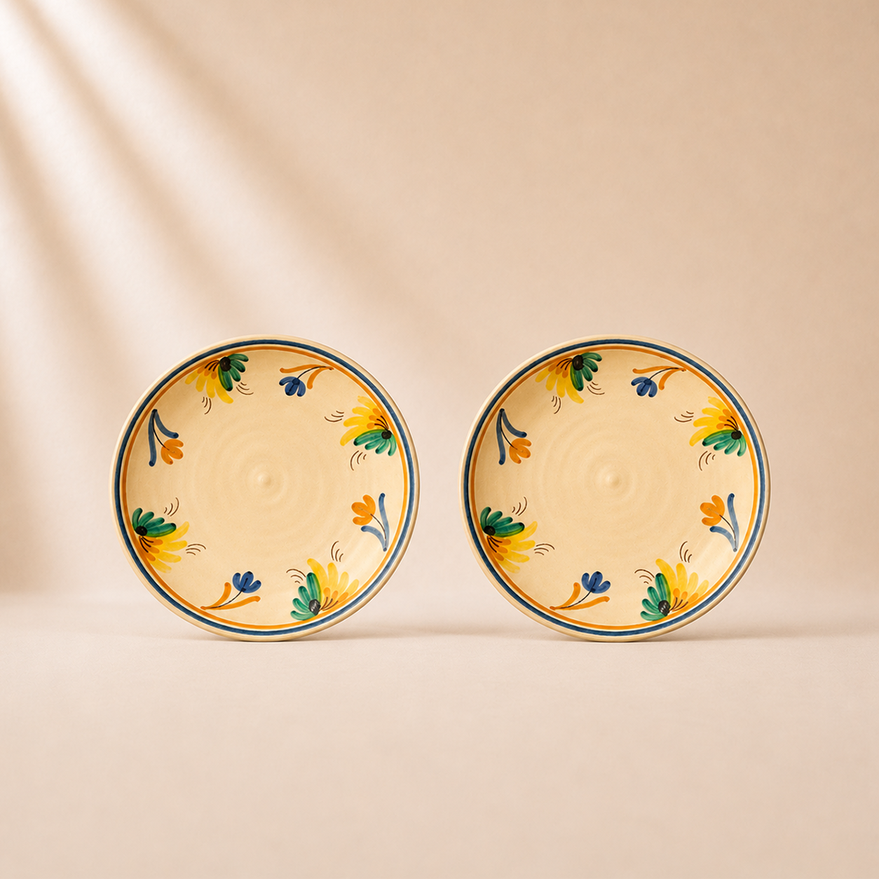 Two ceramic plates with floral patterns on a beige background