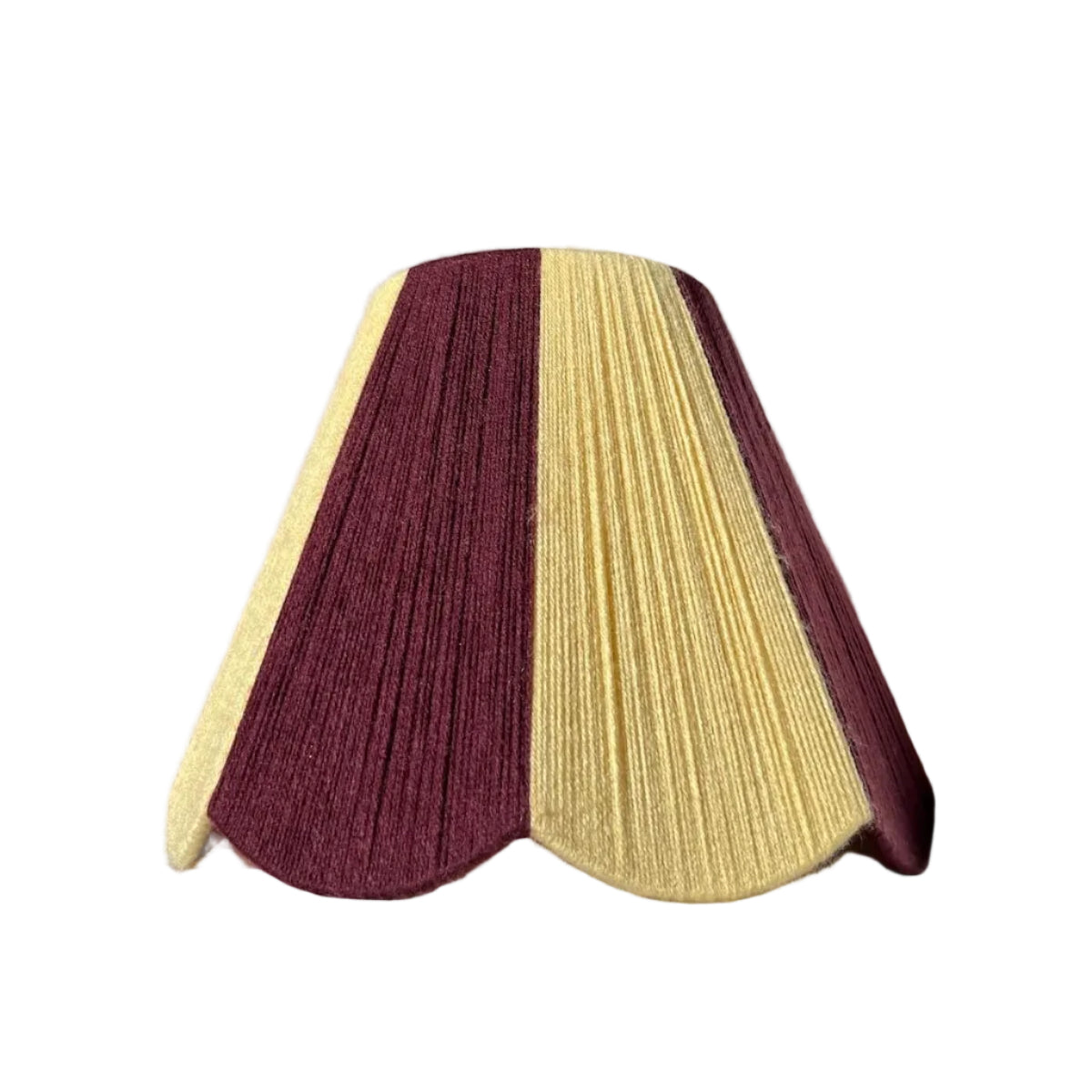 A Slice Shades lampshade with a handowoven yarn design of textured buttermilk yellow and deep burgundy, displayed on a draped white fabric background.