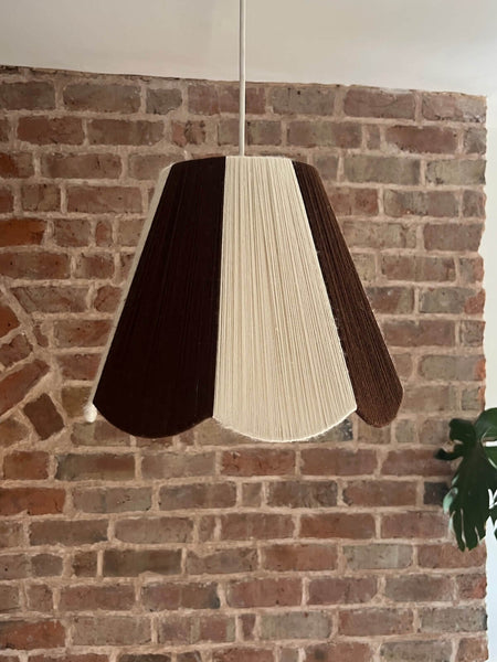 A handmade yarn scallop lampshade by Slice Shades in Ecru and Cocoa white and brown.