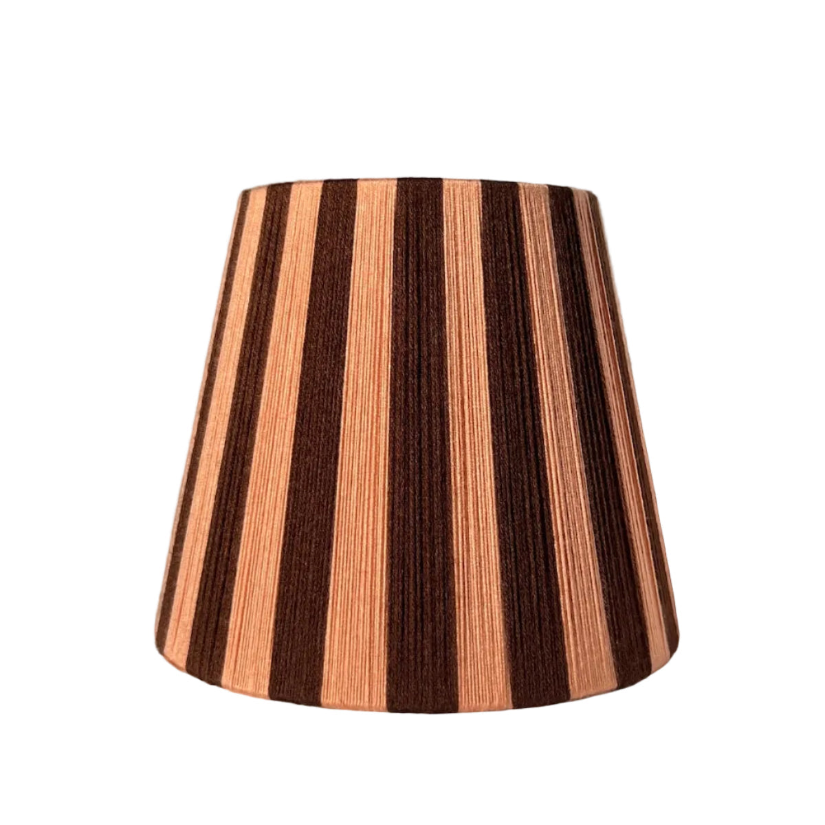 A Slice Shades handwoven striped yarn lampshade with alternating vertical stripes of dark brown and a warm peach-pink, displayed on a draped white fabric background on side.
