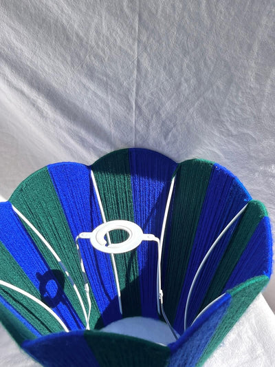 A Slice Shades handwoven yarn striped Scallop Lampshade in the sun in Cobalt Blue & Forest Green.