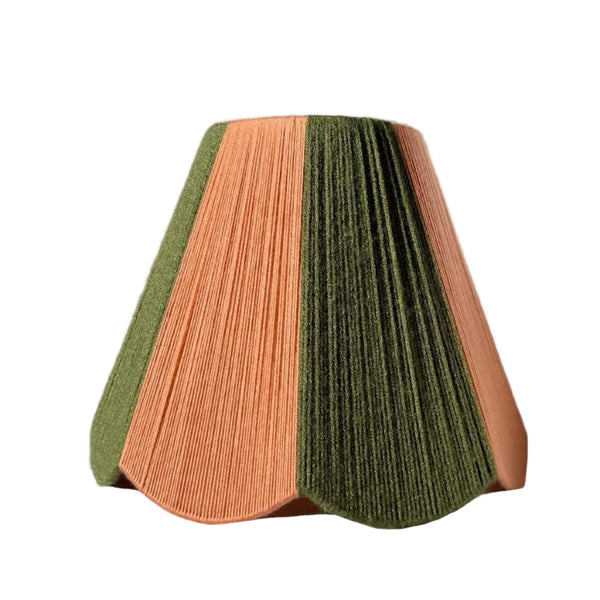 A slice shades handwoven striped scallop yarn lampshade in olive green and plaster pink with white background.
