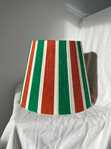 A Slice Shades handwoven yarn striped lampshade in Rust, Ecru & Jade Green on a white background.