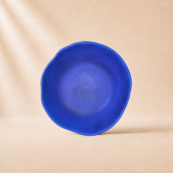 Blue ceramic bowl on a beige background