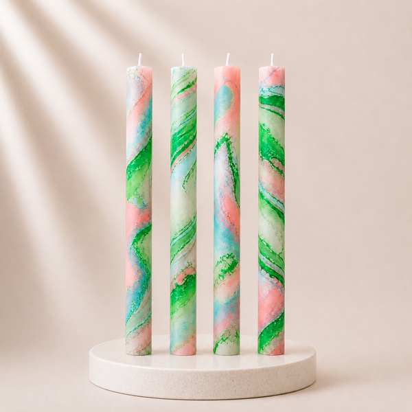 Four multicolored candles on a white stand against a beige background