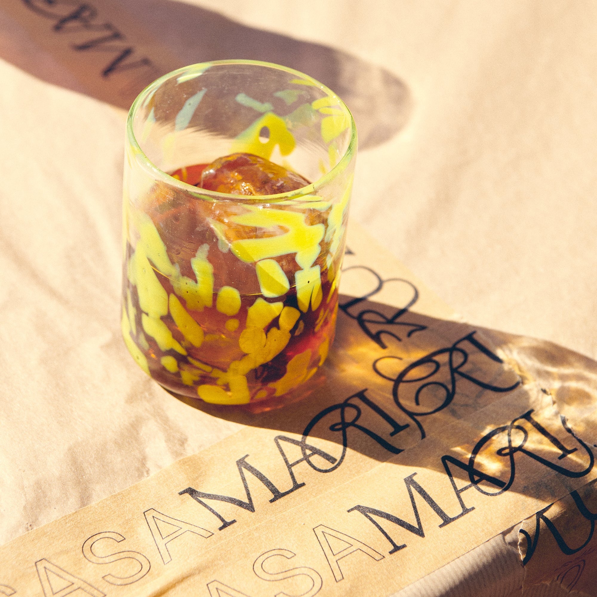 Colorful glass on a textured surface with casa maricruz - lifestyle