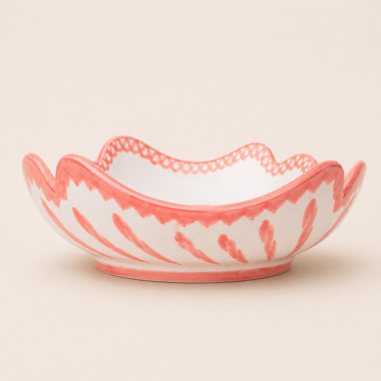 Decorative bowl with pink and white pattern on a beige background
