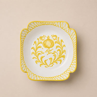 Decorative plate with yellow floral design on a beige background