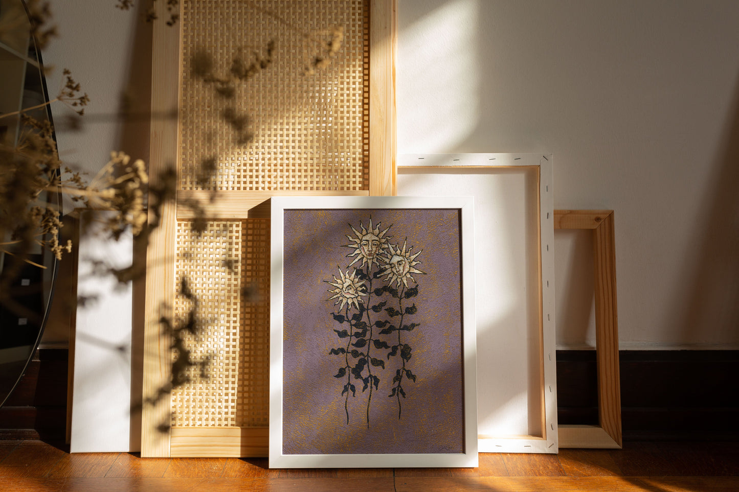 textured wall art print in purple and yellow tones featuring three sunflowers with human faces in every bloom