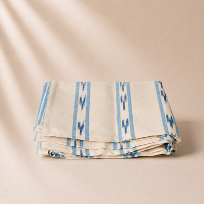 Folded fabric with blue patterns on a beige background