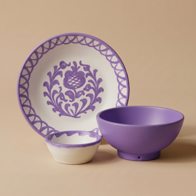 Ceramic plate, bowl, and small dish with lilac floral patterns on a beige background