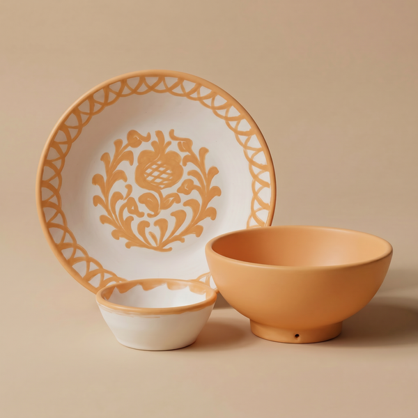 Ceramic plate with decorative pattern, bowl, and small dish on a beige background