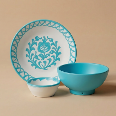 turquoise and white ceramic plate with decorative rooster design next to a turquoise bowl on a beige background