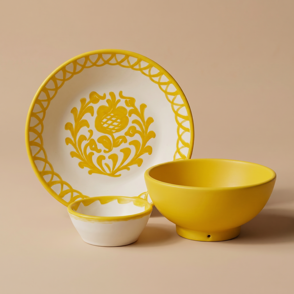 Ceramic plate, bowl, and saucer with yellow floral design on a beige background