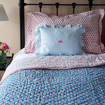 teal and pink floral block printed quilt