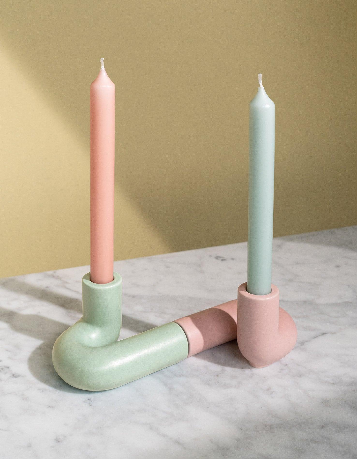 Two light mint and pink candles in OCTAEVO’s Templo Candle Holder, a modern handcrafted artisan ceramic piece. 