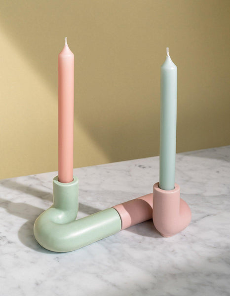 Two light mint and pink candles in OCTAEVO’s Templo Candle Holder, a modern handcrafted artisan ceramic piece. 