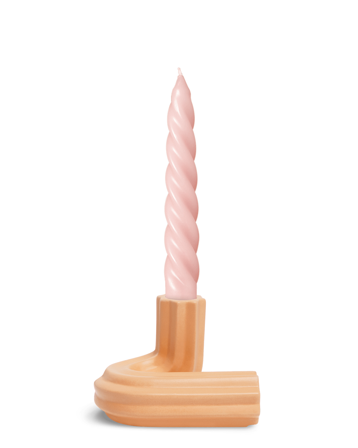 A pink spiral candle sits in Orange OCTAEVO Templo Candle Holder, a peach ceramic piece, against a white background.