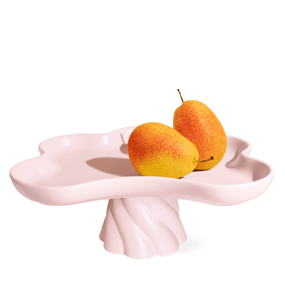 The Octaevo Templo High Tray is a light pink stoneware stand with scalloped, flower-shaped edges—a charming centerpiece.