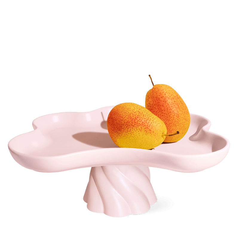 The Octaevo Templo High Tray is a light pink stoneware stand with scalloped, flower-shaped edges—a charming centerpiece.