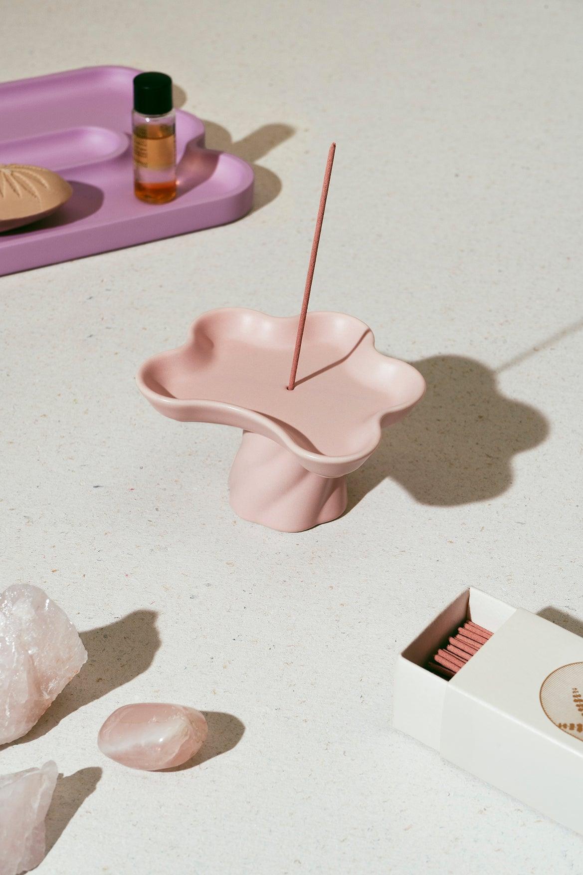 The Octaevo Templo Incense Holder in pink with crystals, matches, and catchall tray displayed on a light surface.